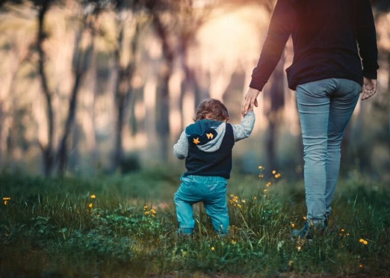 Mother with Toddler Walking in the Woods