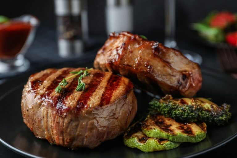 Two Steaks on a Plate With Vegetable Side