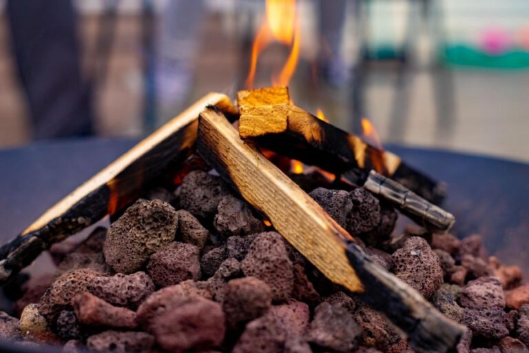 Sticks Burning Over Lava Rocks in Fire Pit