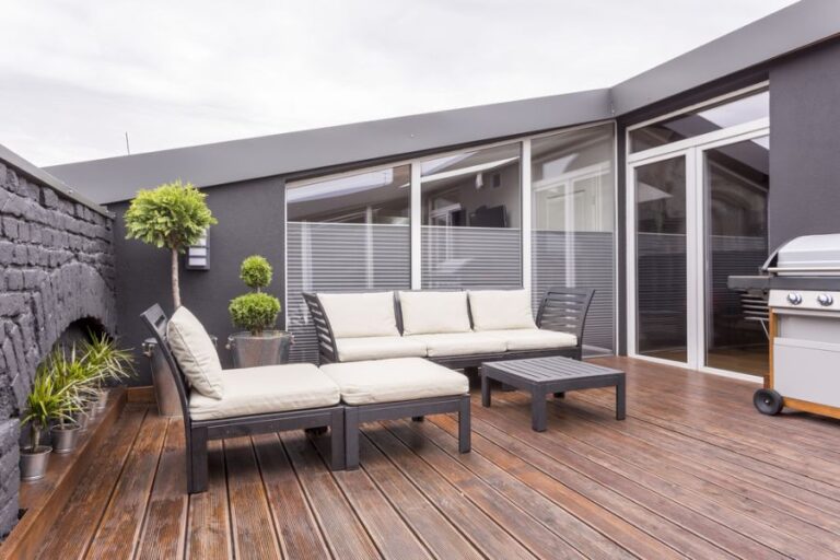 Sunbed, Garden Sofa, and Coffee Table on Wet Wooden Floor of Terrace