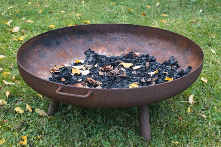 Rusted, Round Fire Bowl With Ash and Leaves Inside