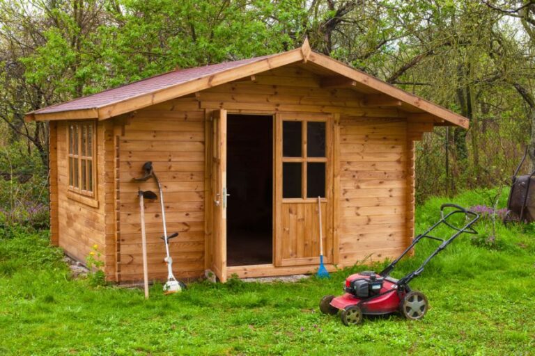 Garden Shed With Various Garden Tools in Front