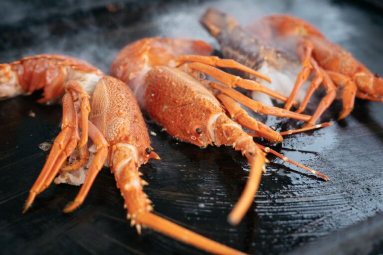 Halved Lobsters Sizzling on a Griddle