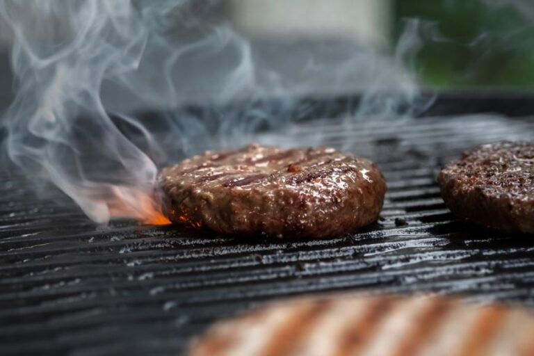 Hamburgers Cooking on a Gas Grill Outside
