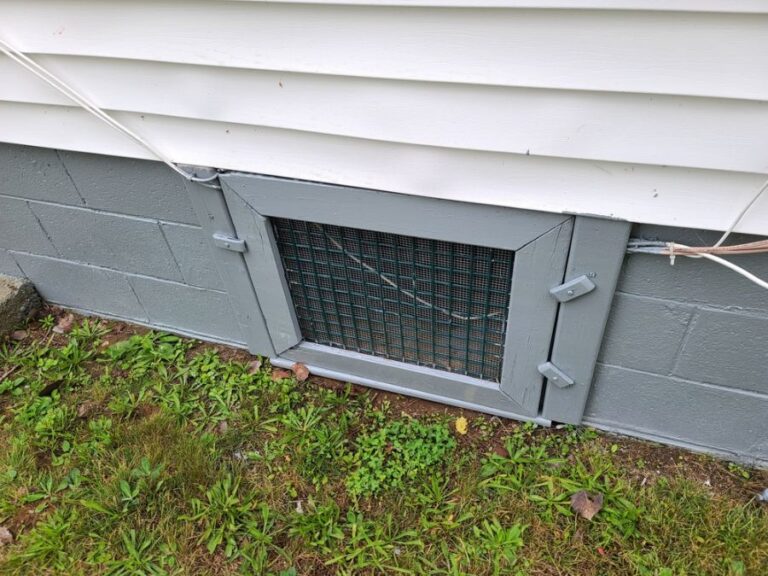 Old Door Under the Siding Leading to the Crawl Space