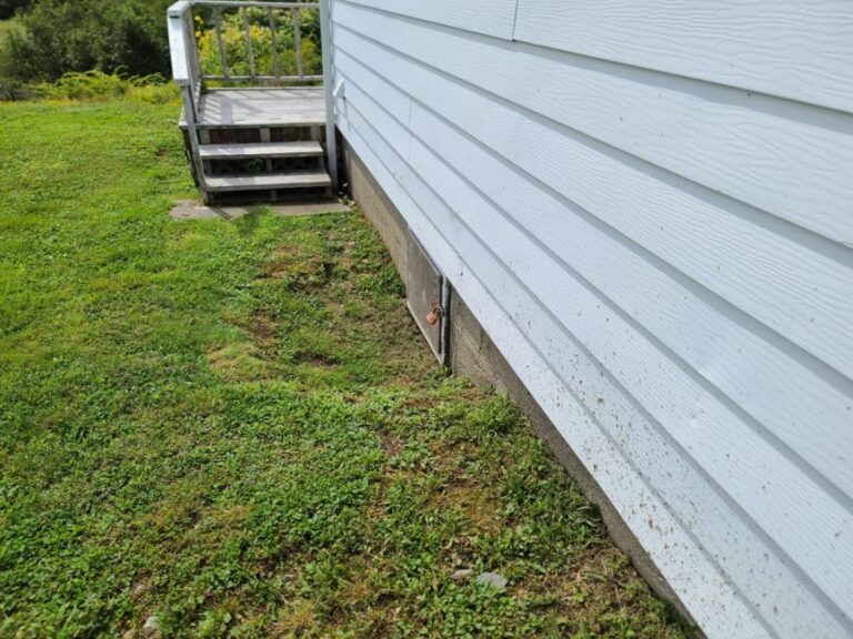 Crawlspace Door With a Lock at the Bottom of a House
