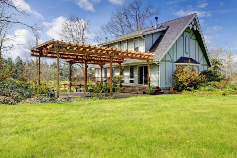 Rustic Farmhouse With a Front Deck and Large Pergola