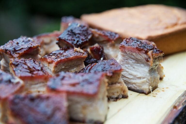 Smoked Pork Belly Cut Into Chunks on a Cutting Board