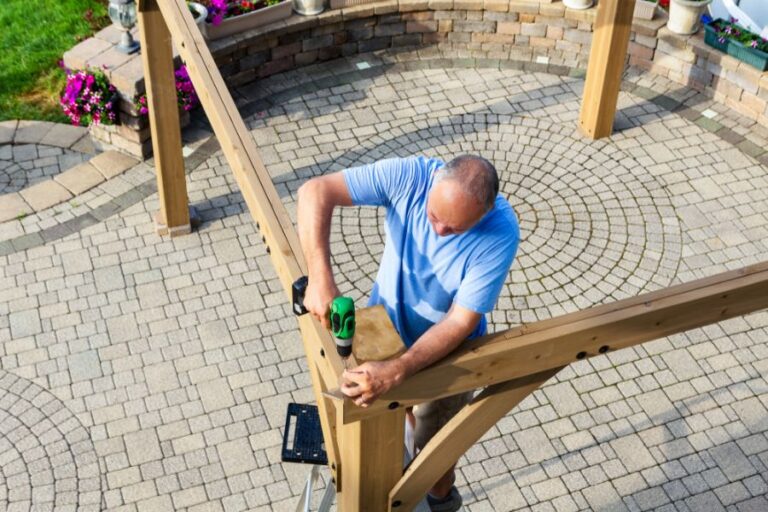 Man Building a Pergola Over a Patio
