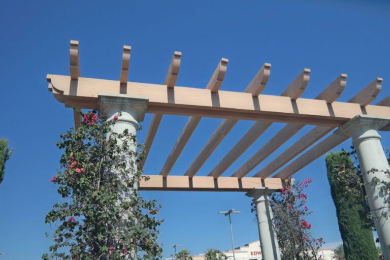 White Pergola With Flowers and Vines on Columns