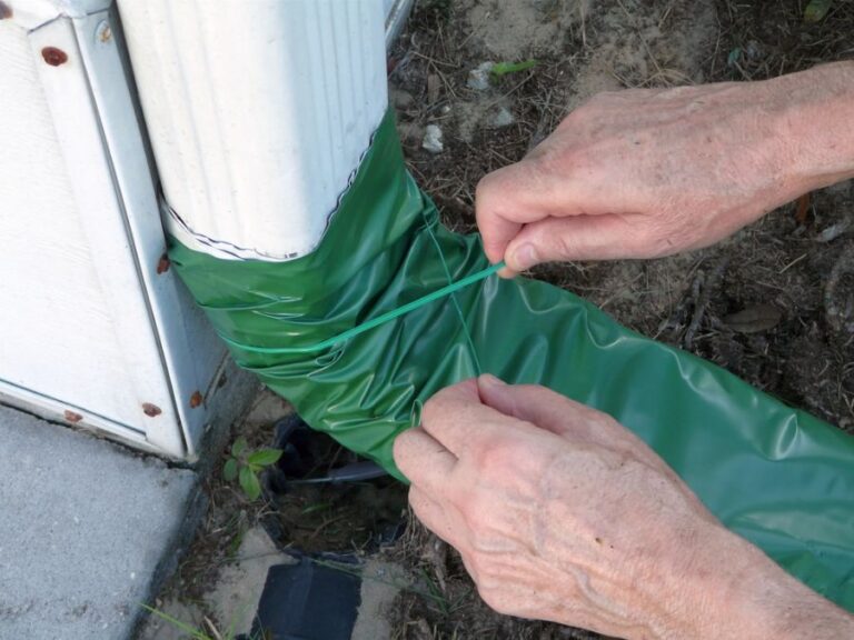 Man Tying Rollup Drain Extender to a Downspout