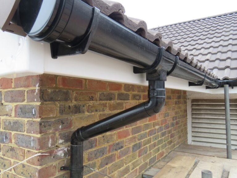 New Black PVC Gutters and Downspouts on a House