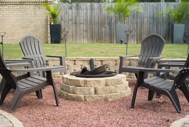 Firepit With Wood Surrounded by Chairs