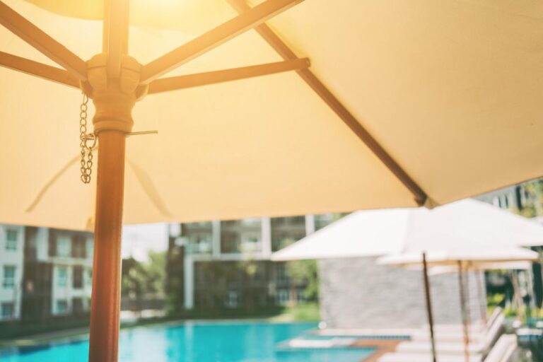 Open Umbrella in the Sun Near a Pool