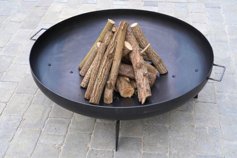 Unlit Firepit With Pieces of Wood Stacked in the Middle