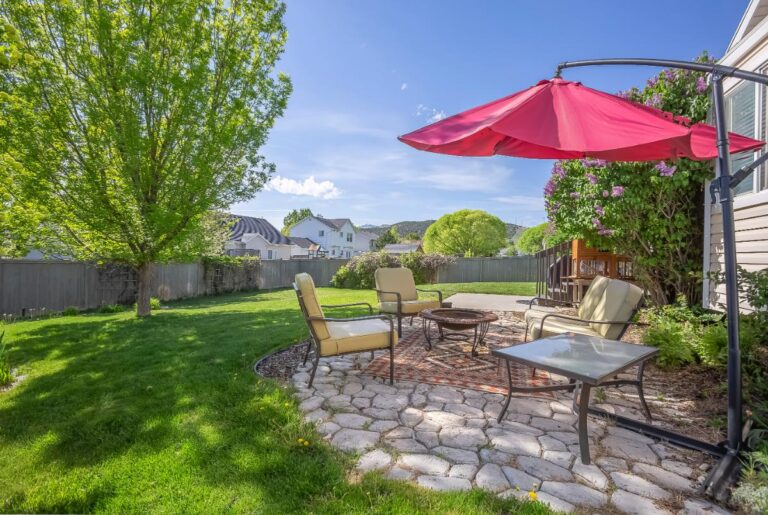 Red Offset Umbrella Over Patio Furniture in the Backyard