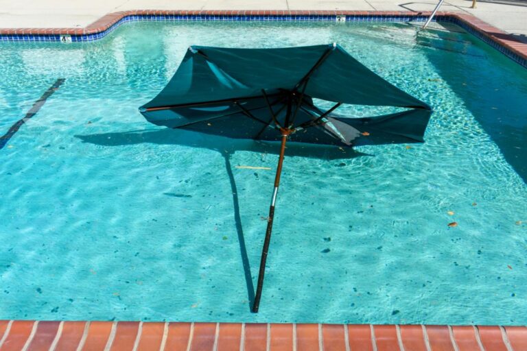 Broken Umbrella in a Pool After a Windy Storm